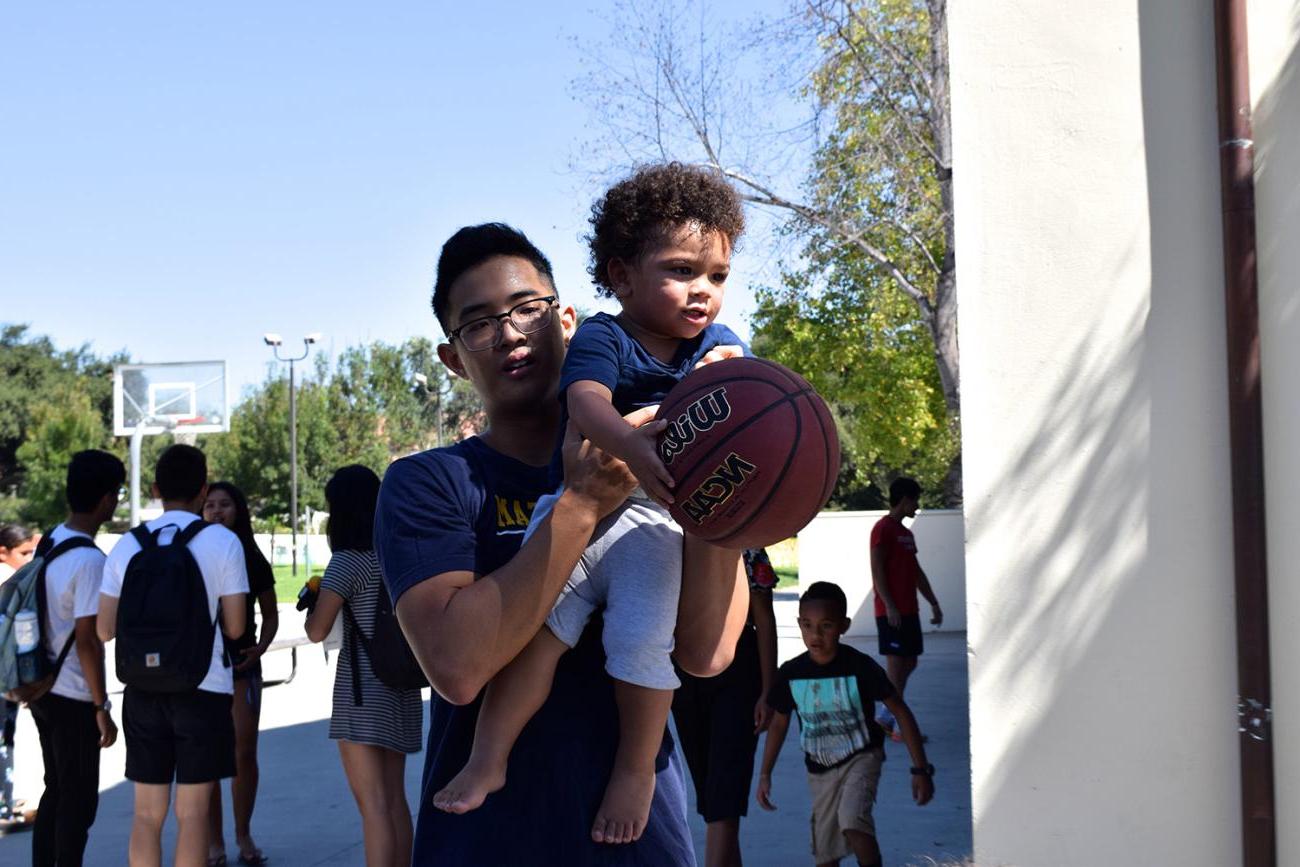 Nathan Hahn ('19) helping a STEP student with basketball. 