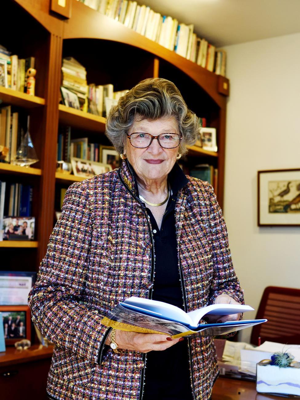 Photo of Blaisdell Award winner Mary Walshok, Class of 1964, in front of book cases