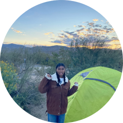 Arianna in front of a tent in the desert