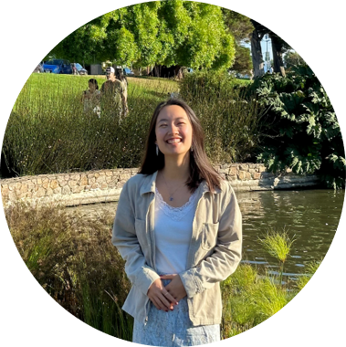 Sydney Tai in front of a decorative pond